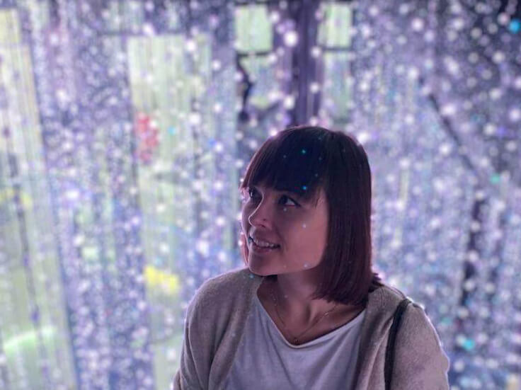 Portrait photo at Cosmos Museum. Background of blue light strings. 