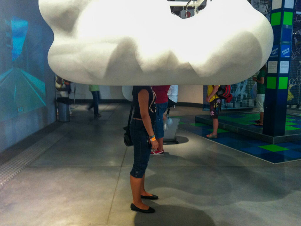 Copernicus Science Center. Artificial Cloud covers head of a standing person. 